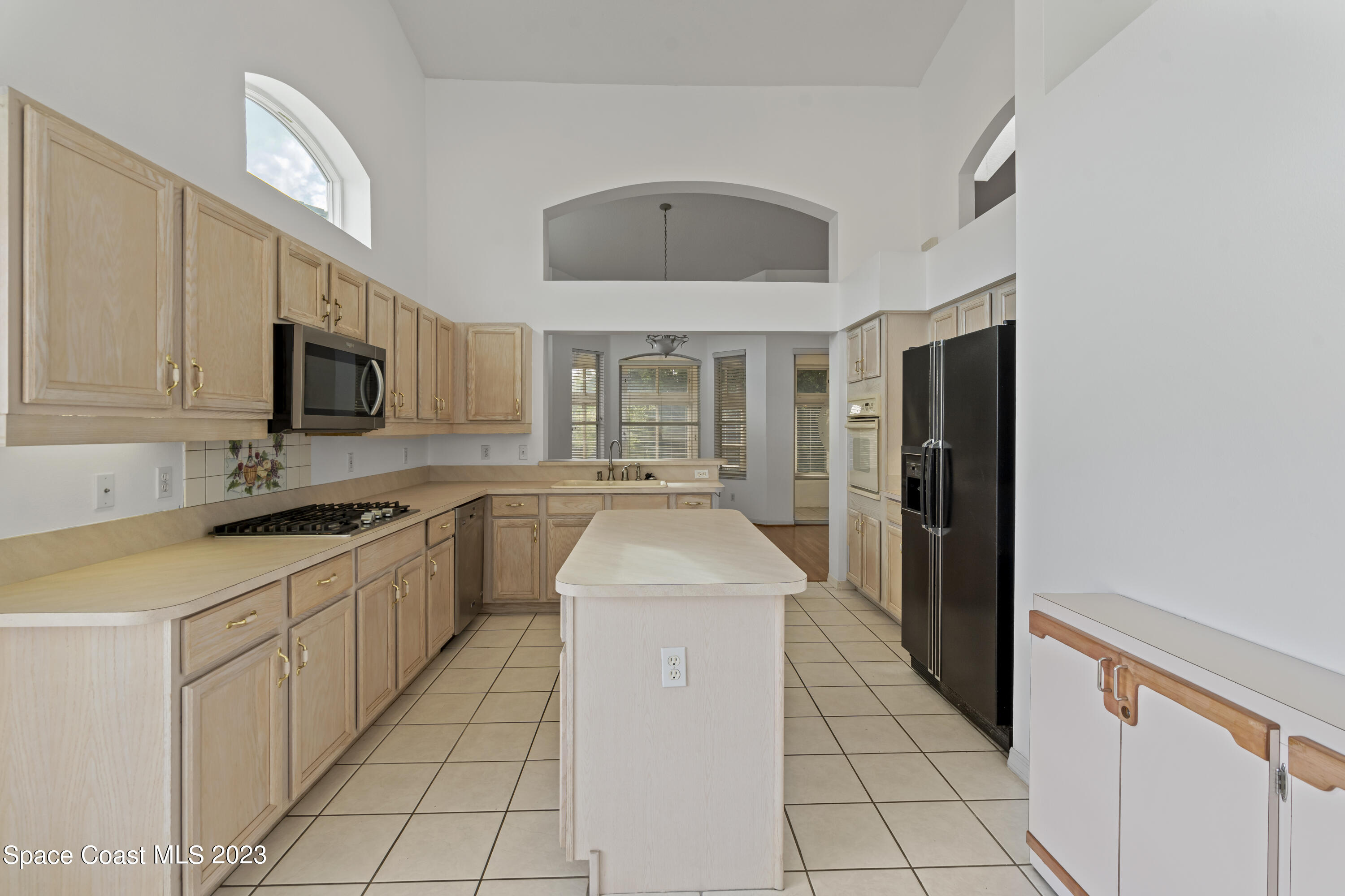 448 Renaissance Avenue Melbourne, FL 32940 - Photo 36 of 57 a kitchen with stainless steel appliances granite countertop a refrigerator and a stove top oven