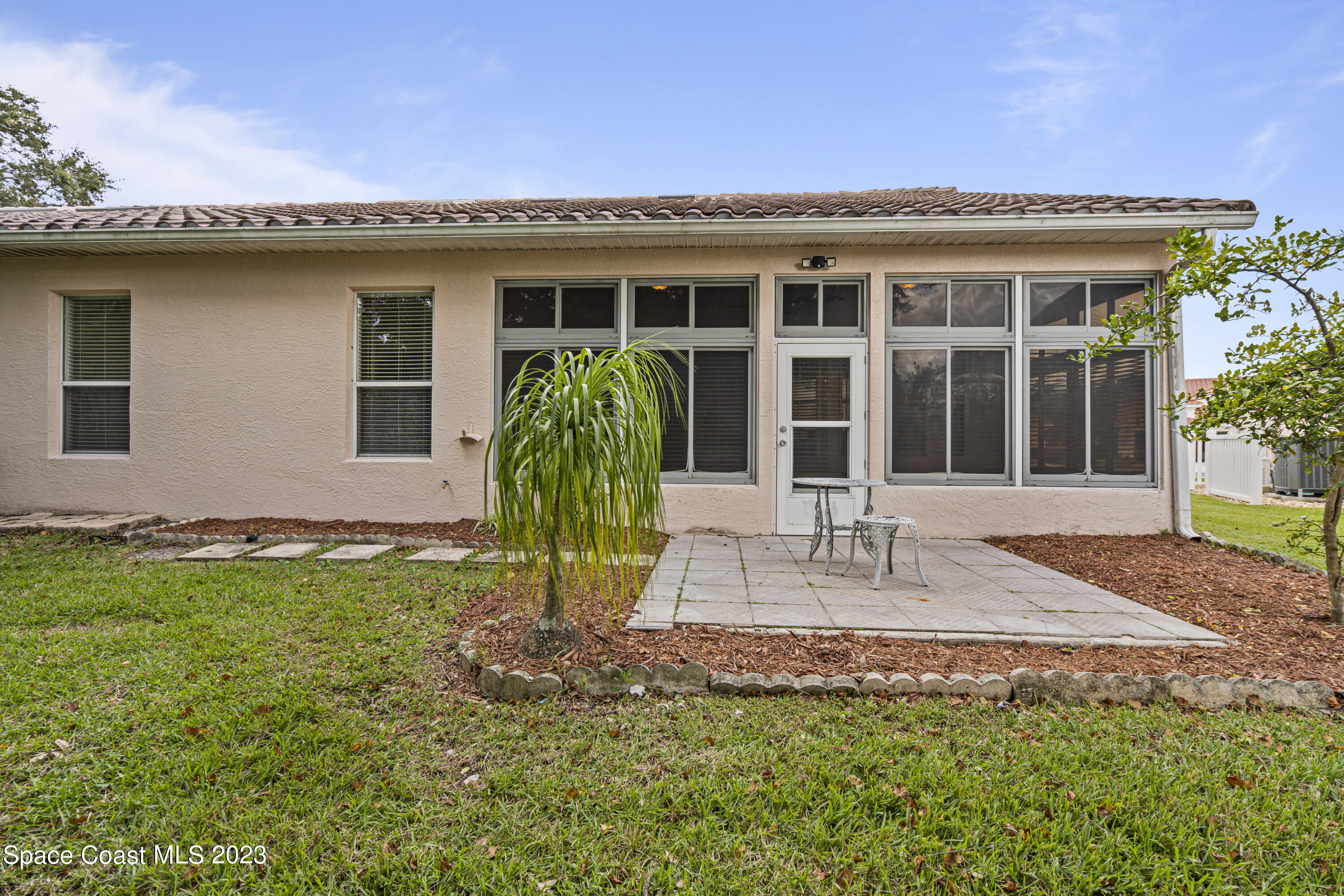 448 Renaissance Avenue Melbourne, FL 32940 - Photo 44 of 57 a front view of a house with a garden