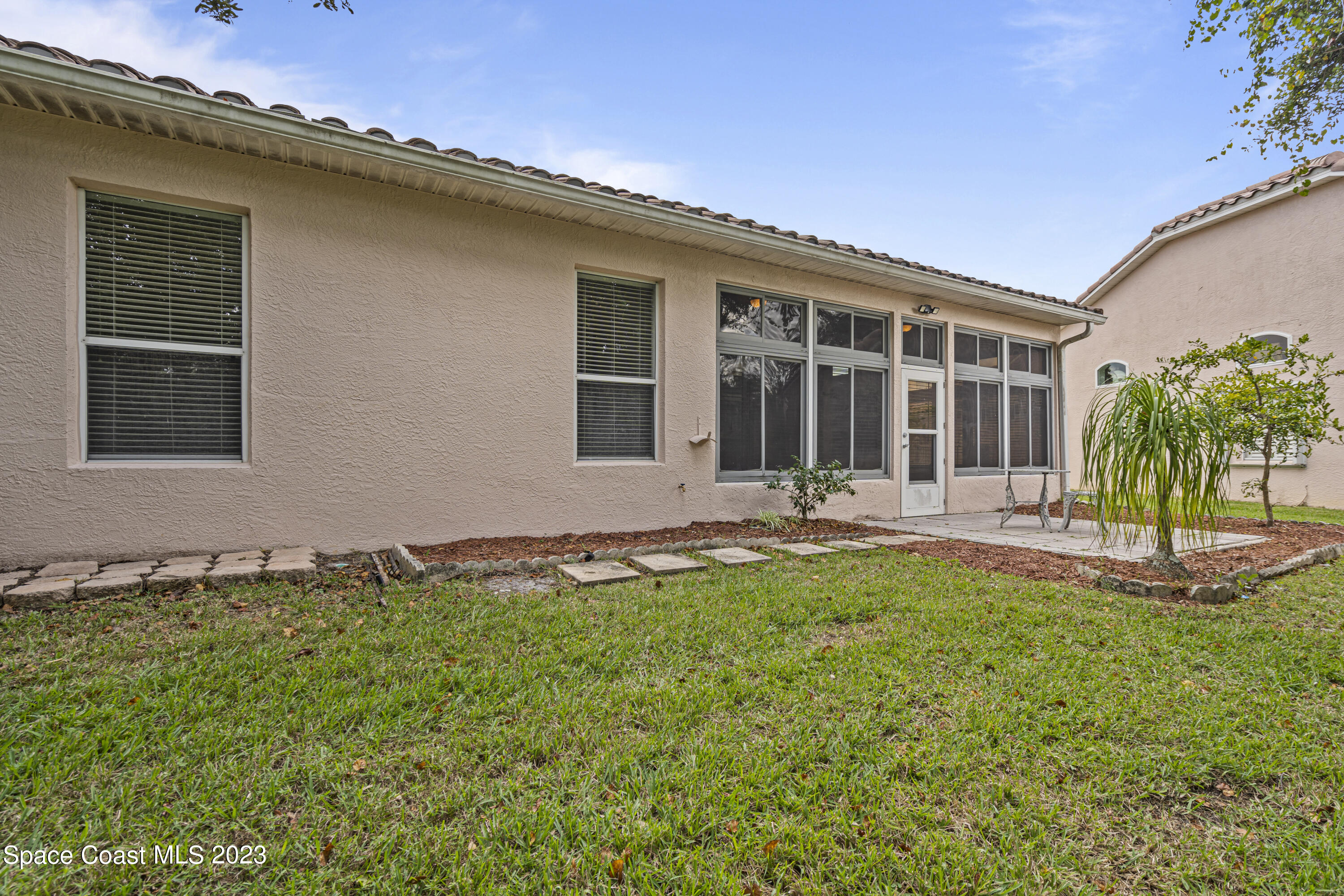 448 Renaissance Avenue Melbourne, FL 32940 - Photo 45 of 57 front view of a house with a yard
