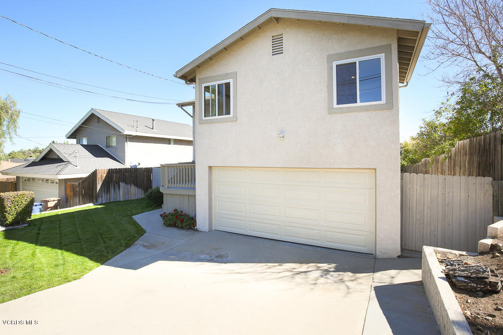 254 Maple Road Newbury Park, CA 91320 - Photo 2 of 24 a front view of a house with a yard and garage