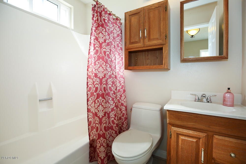 254 Maple Road Newbury Park, CA 91320 - Photo 14 of 24 a bathroom with a sink a toilet and shower curtain