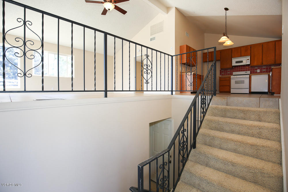 254 Maple Road Newbury Park, CA 91320 - Photo 4 of 24 a view of staircase with lots of frames on wall and a window