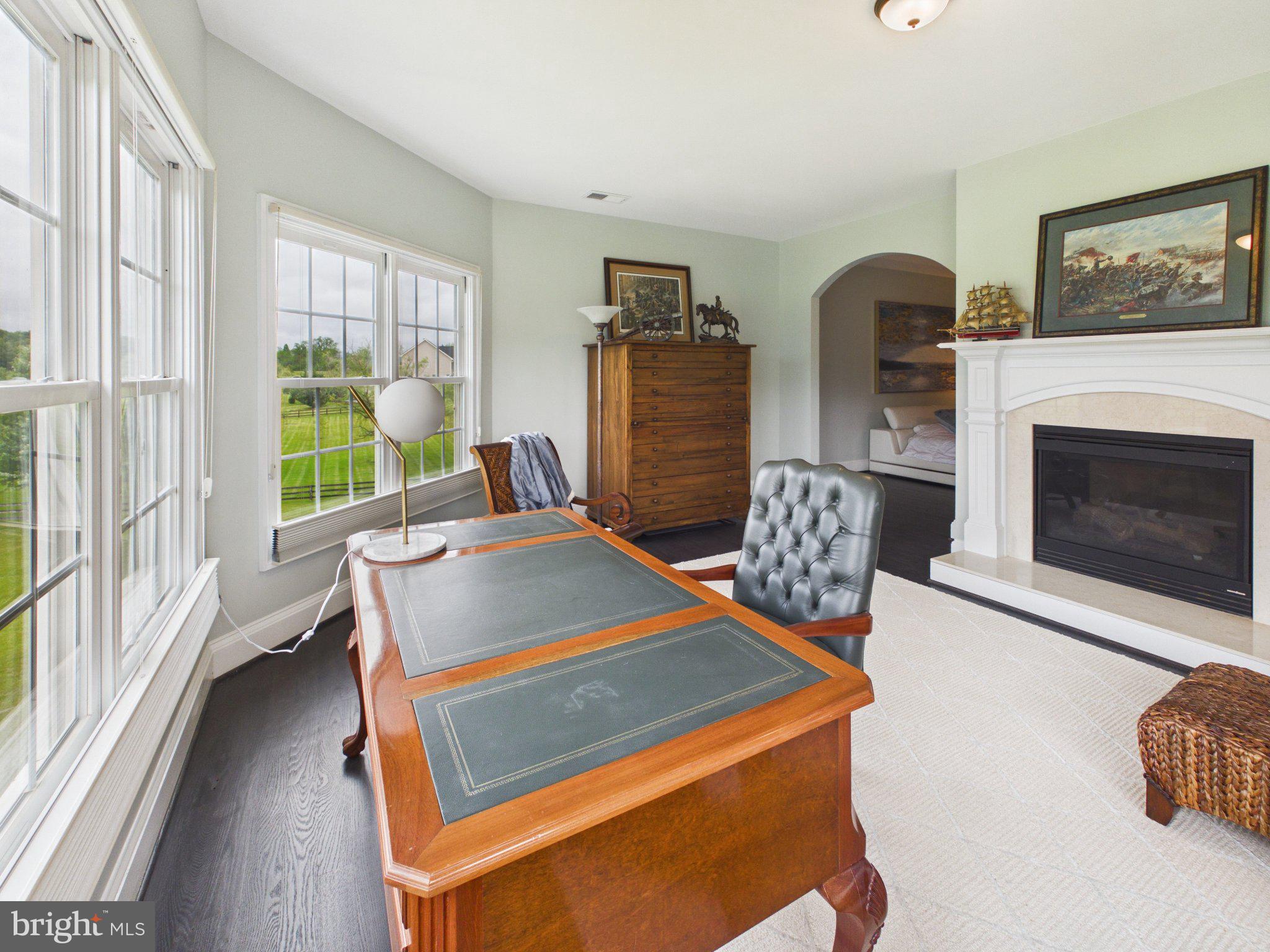38565 Piggott Bottom Road Hamilton, VA 20158 - Photo 42 of 85 a living room with furniture a flat screen tv and a fireplace