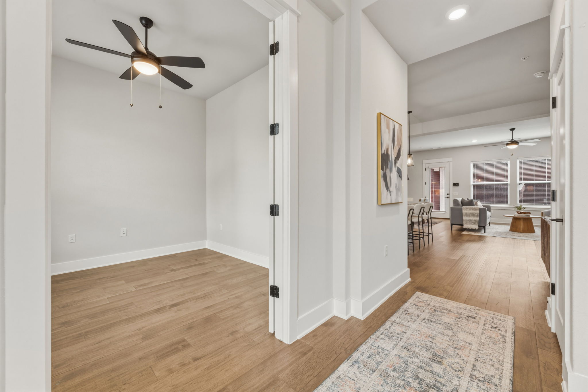 2929 Moreno Street Austin, TX 78723 - Photo 4 of 40 Dedicated room featuring wood-finish flooring, a ceiling fan with integrated lighting, and crown molding
