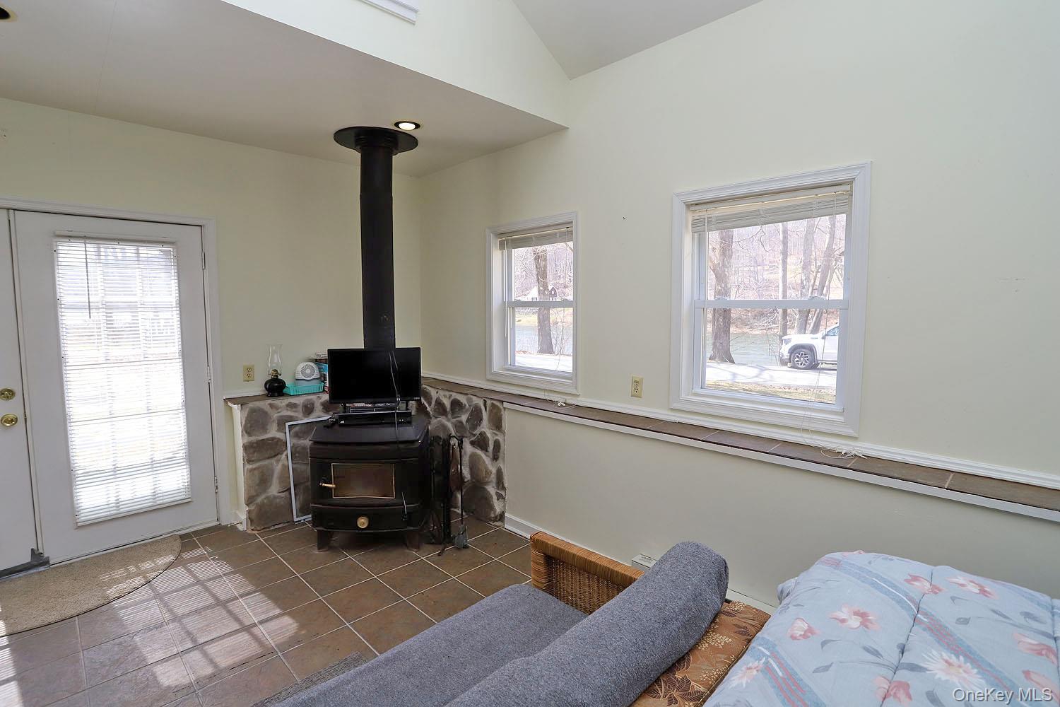 860 River Road Callicoon, NY 12723 - Photo 11 of 27 Woodstove and French doors to patio.