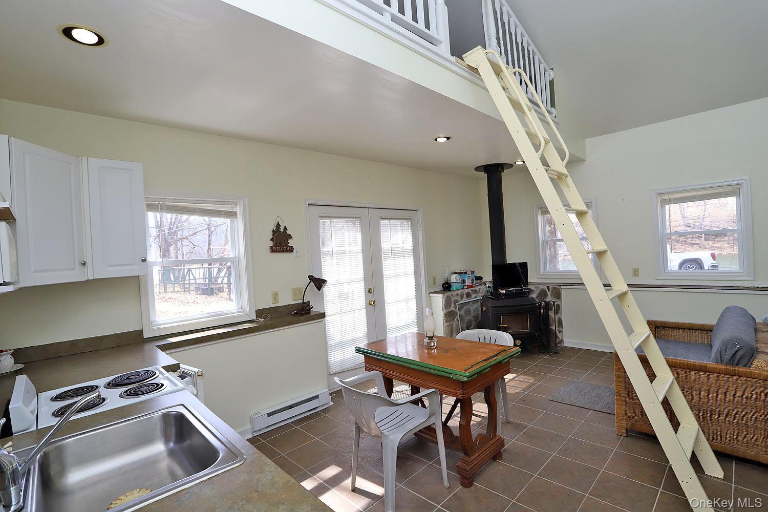 860 River Road Callicoon, NY 12723 - Photo 8 of 45 a living room with furniture a fireplace and a large window