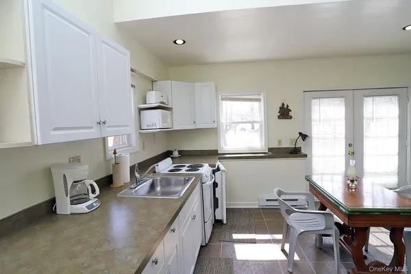 a kitchen with stainless steel appliances granite countertop a stove a sink dishwasher and cabinets with wooden floor