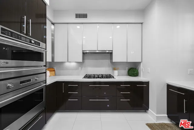 a kitchen with stainless steel appliances a stove and cabinets
