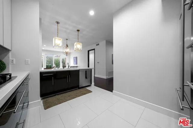 a kitchen with stainless steel appliances a sink and a stove top oven