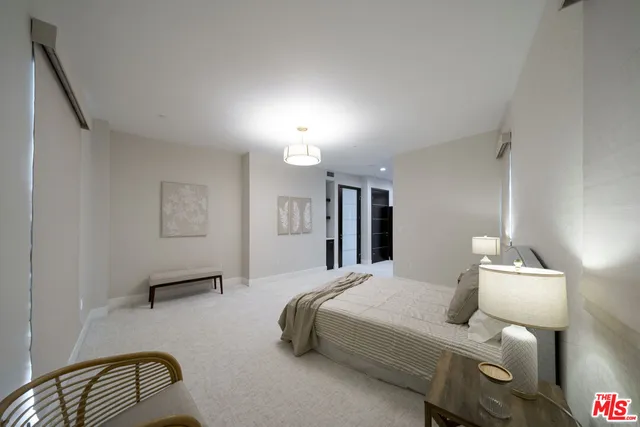 a bedroom with a bed and a lamp