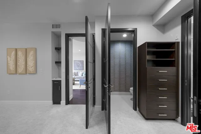 a view of an empty room with closet and bathroom