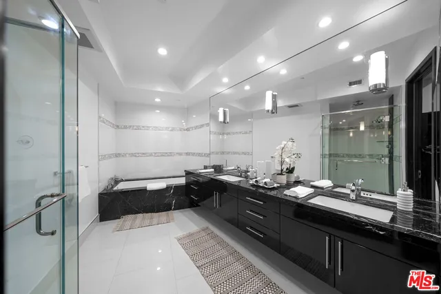 a large bathroom with a large tub and sink