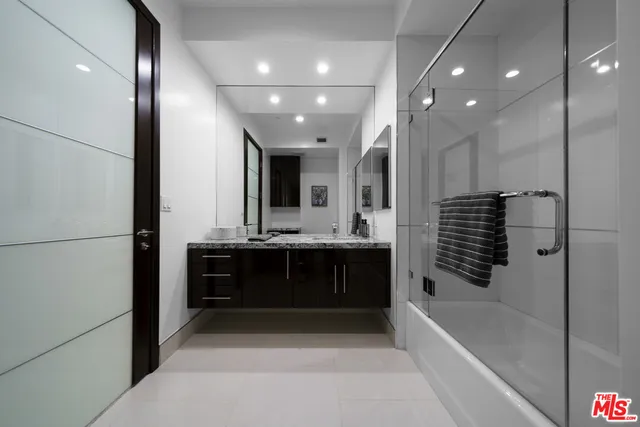 a bathroom with a large tub a sink a vanity and shower