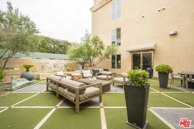 a view of a patio with couches and potted plants