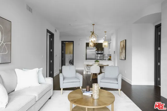 a living room with furniture and a dining table