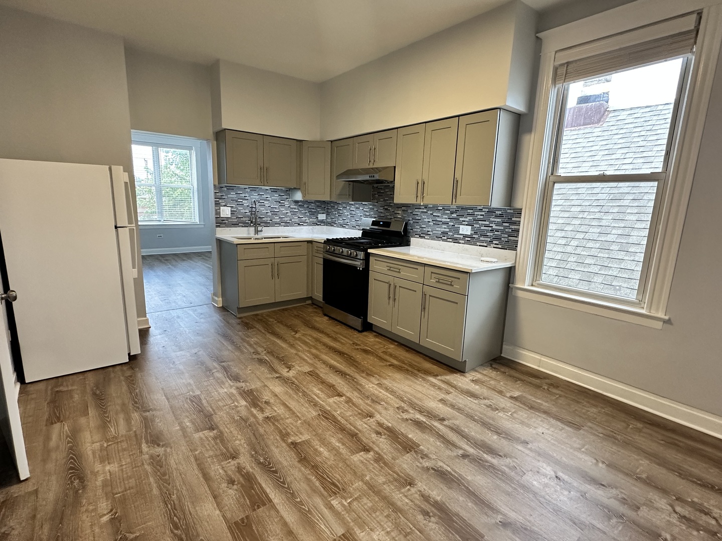 931 West 32nd Street, Unit 2F Chicago, IL 60608 - Photo 2 of 4 a kitchen with a refrigerator and a stove top oven