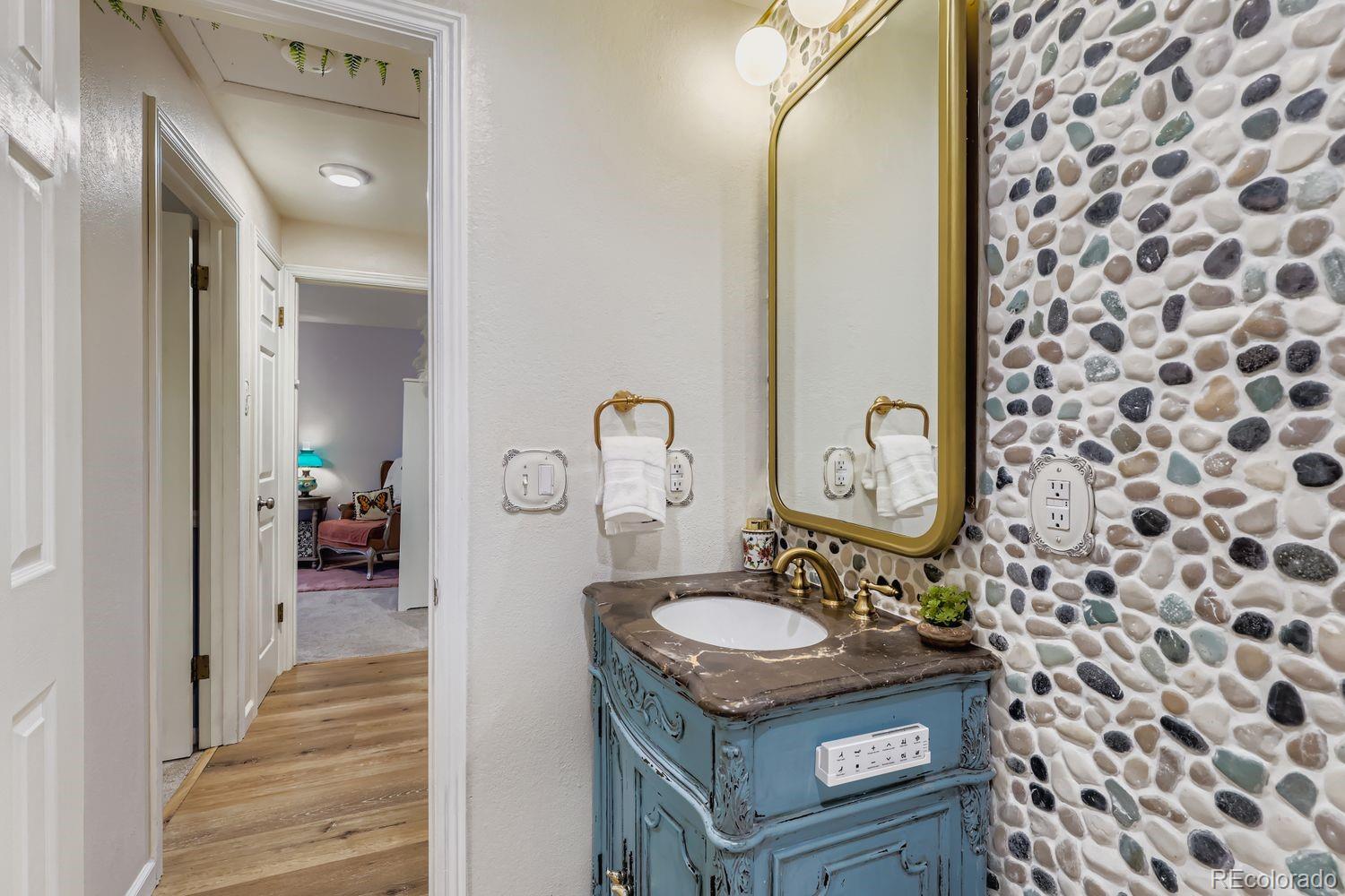7049 Reed Court Arvada, CO 80003 - Photo 12 of 28 a bathroom with a sink and a mirror