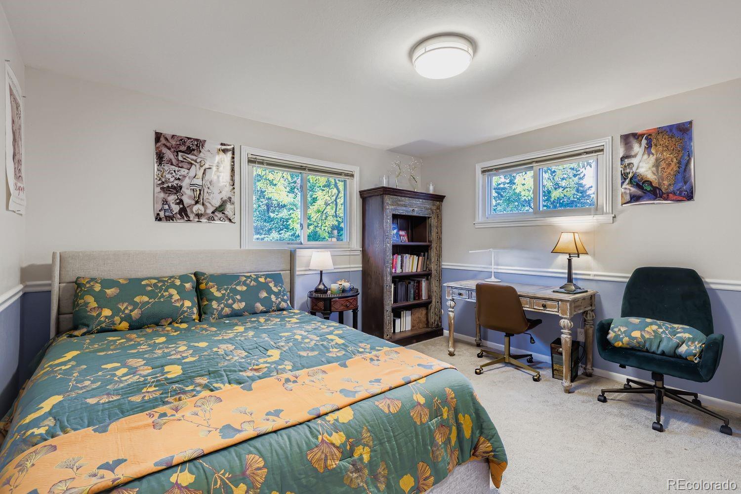 7049 Reed Court Arvada, CO 80003 - Photo 18 of 28 a bedroom with a bed and furniture