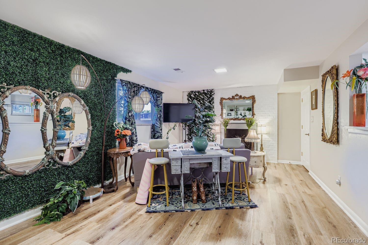 7049 Reed Court Arvada, CO 80003 - Photo 20 of 28 a view of a dining room with furniture window and wooden floor