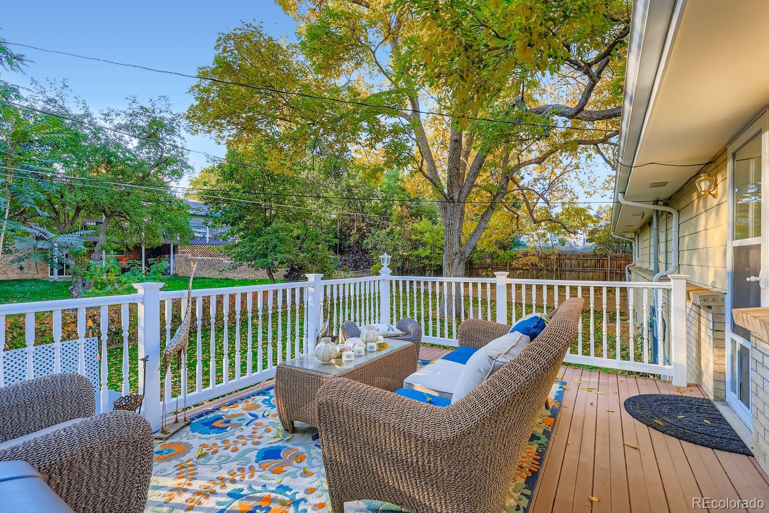 7049 Reed Court Arvada, CO 80003 - Photo 24 of 28 a balcony with furniture and wooden floor