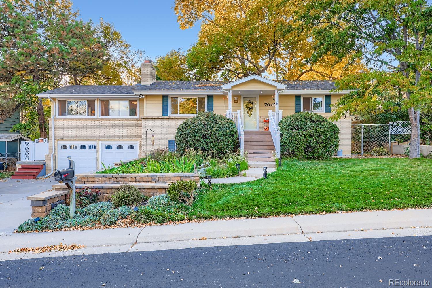 7049 Reed Court Arvada, CO 80003 - Photo 3 of 28 front view of house with a yard
