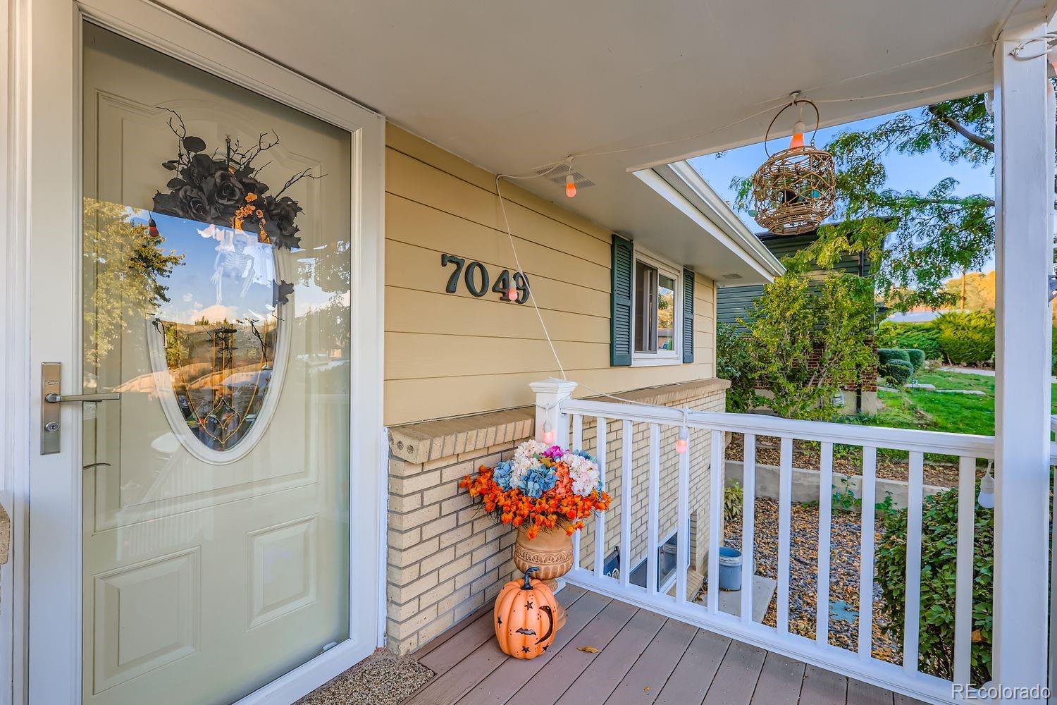 7049 Reed Court Arvada, CO 80003 - Photo 4 of 28 a view of entryway with wooden floor