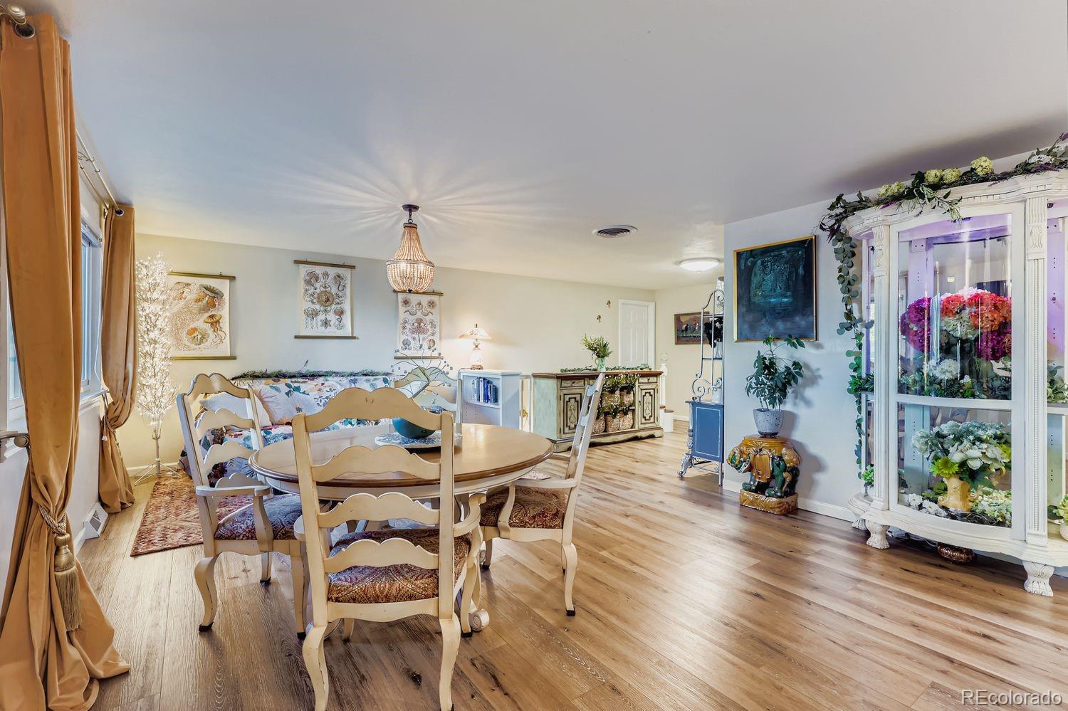 7049 Reed Court Arvada, CO 80003 - Photo 7 of 28 a dining room with furniture and wooden floor