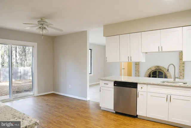 a kitchen with stainless steel appliances granite countertop a sink a stove and refrigerator