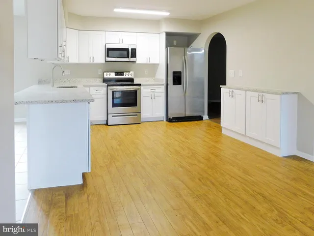 a view of a kitchen with a sink and a large window