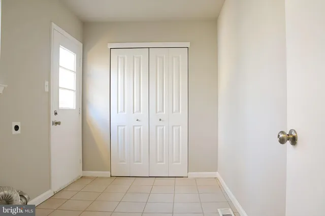 an empty room with windows and closet