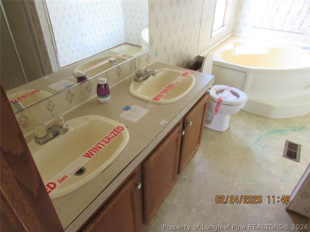 95 Eric Lane Autryville, NC 28318 - Photo 5 of 10 a bathroom with a sink a vanity and a mirror