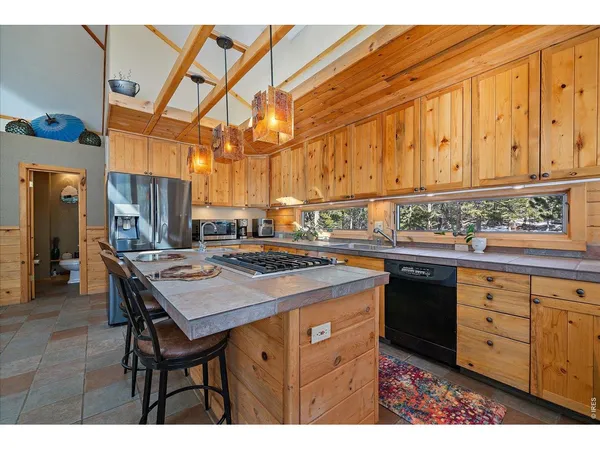 a kitchen with a sink cabinets and wooden floor