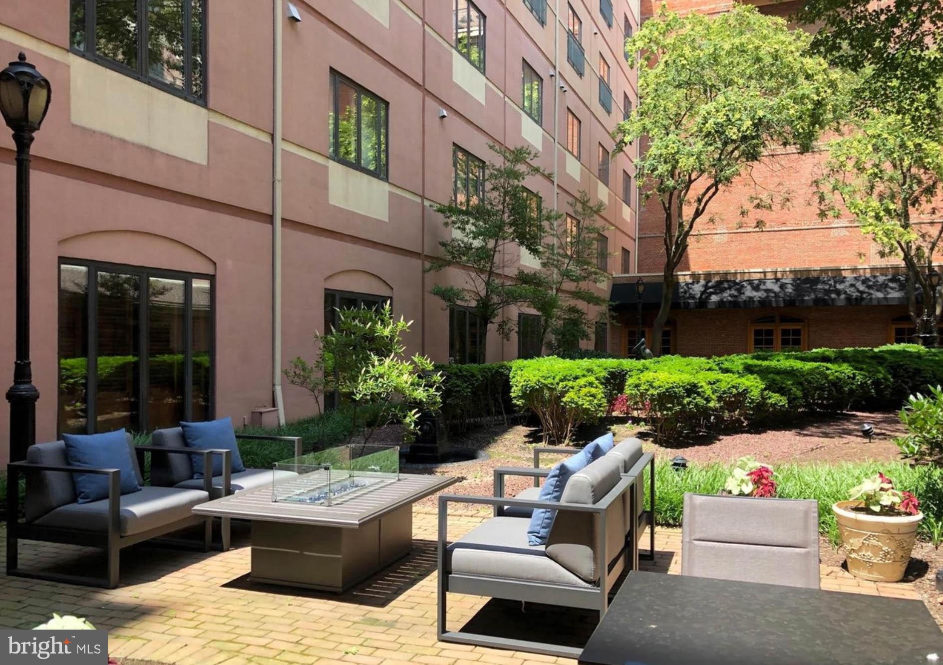 1000 Fell Street, Unit 646 Baltimore, MD 21231 - Photo 43 of 47 a view of a patio with couches table and chairs with plants and trees