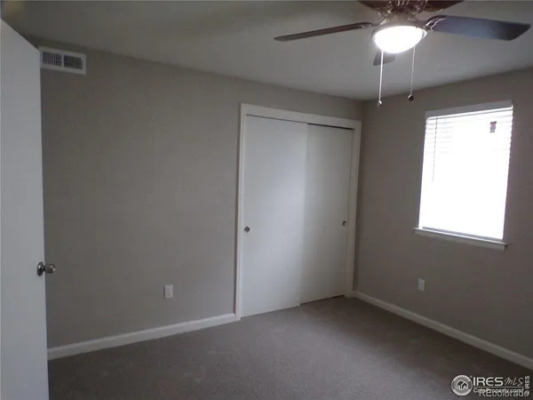 a kitchen with granite countertop a refrigerator and a sink