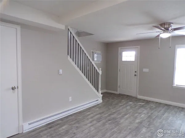 an empty room with closet and a ceiling fan