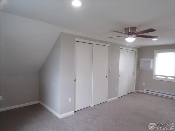 an empty room with windows and closet