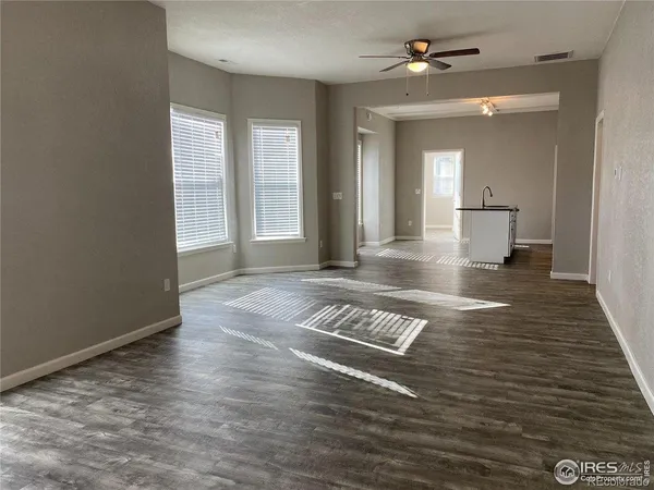 a view of livingroom with hardwood floor and a ceiling fan