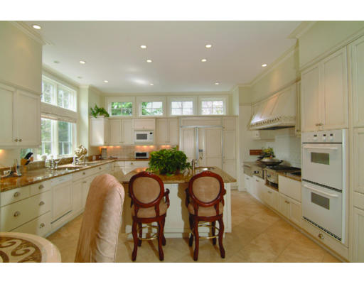 11 Princeton Road Brookline, MA 02467 - Photo 6 of 13 a kitchen with granite countertop a table chairs stove and cabinets