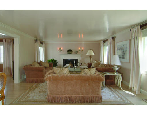 11 Princeton Road Brookline, MA 02467 - Photo 9 of 13 a living room with furniture a fireplace and a chandelier