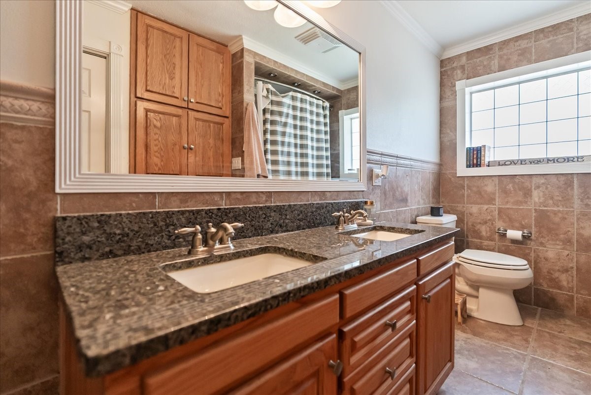 9795 County Road 2249 Sinton, TX 78387 - Photo 24 of 37 a bathroom with a sink and a toilet