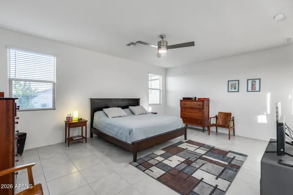 a spacious bedroom with a bed and a chandelier