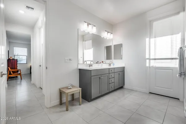 a spacious bathroom with a double vanity sink and a mirror
