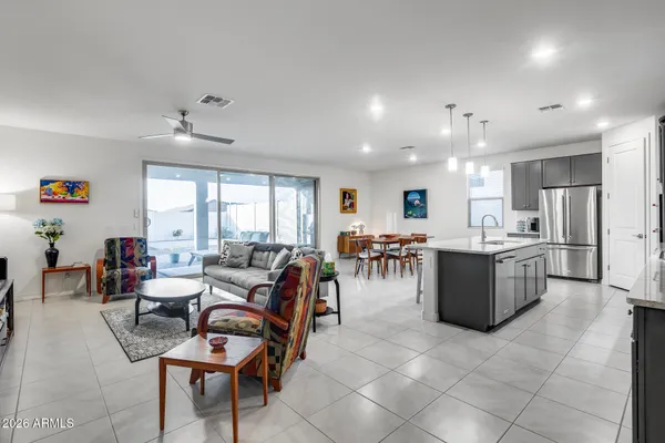 a living room with lots of furniture and kitchen view