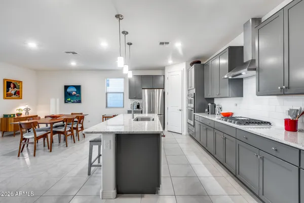 a kitchen with stainless steel appliances kitchen island granite countertop a sink and cabinets