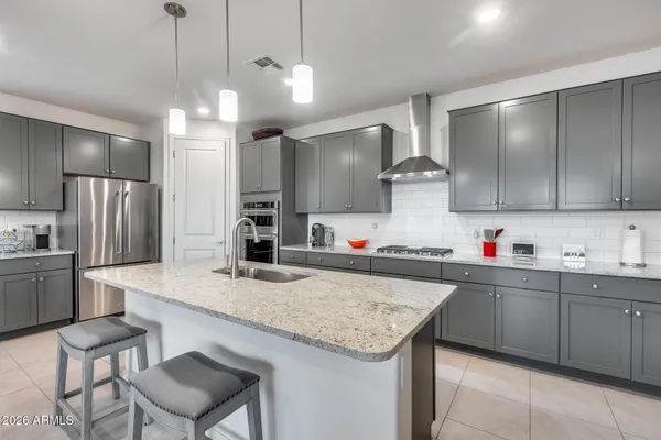 a kitchen with stainless steel appliances granite countertop a sink and refrigerator