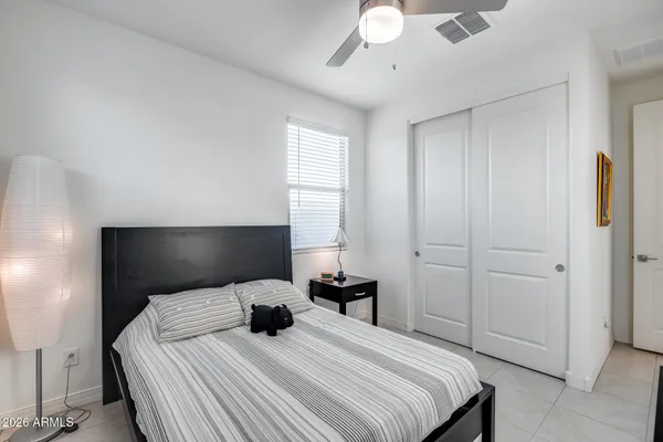 a bedroom with a bed and a chandelier