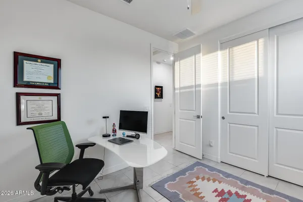 a view of a workspace with furniture and a window