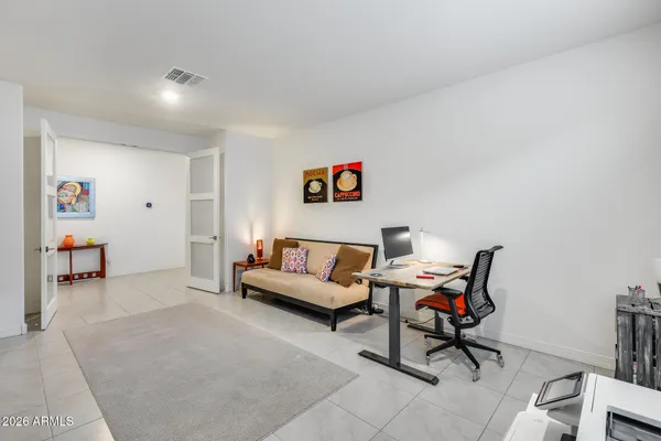 a living room with furniture and a work place area
