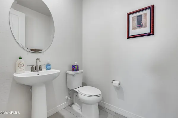 a bathroom with a toilet a sink and a mirror