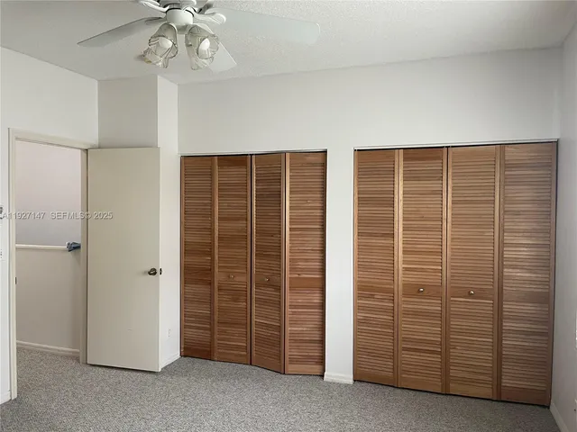 an empty room with a window and wooden floor